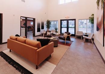 a living room with couches and chairs and a rug