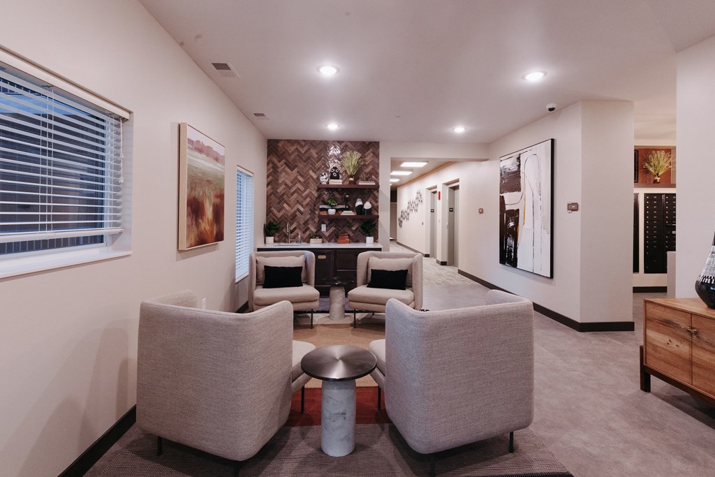 a living room with couches and chairs and a bar in the corner