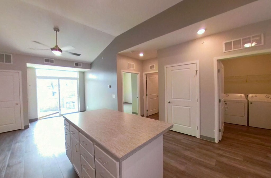 a kitchen with a large island in the middle of it