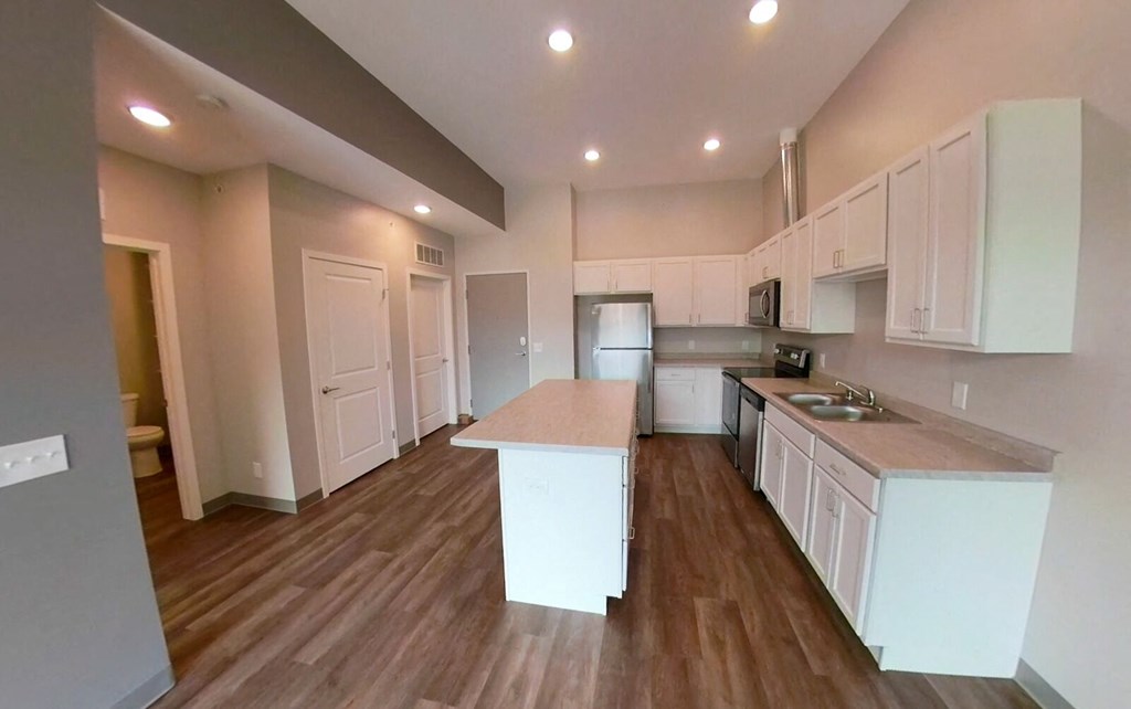 a kitchen with white cabinets and a counter top