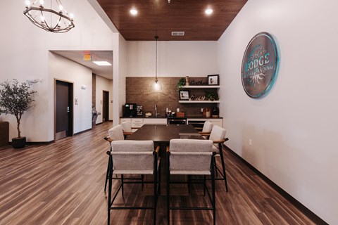 a dining room with a table and chairs and a wall with a sign on it