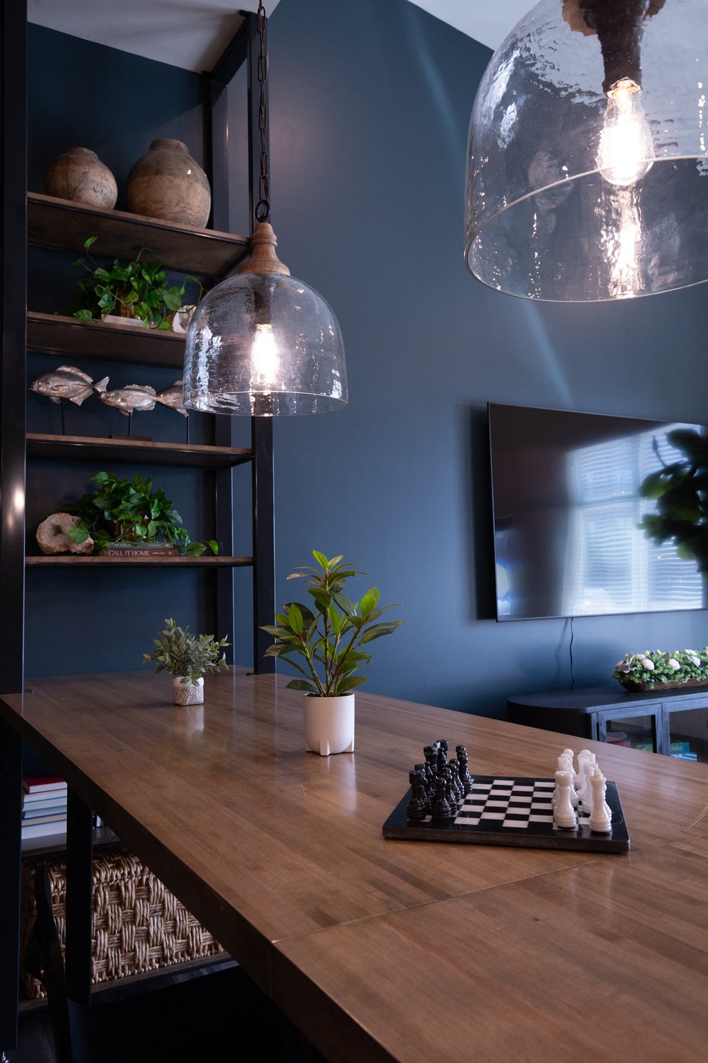 a dining room with a wooden table and two lights