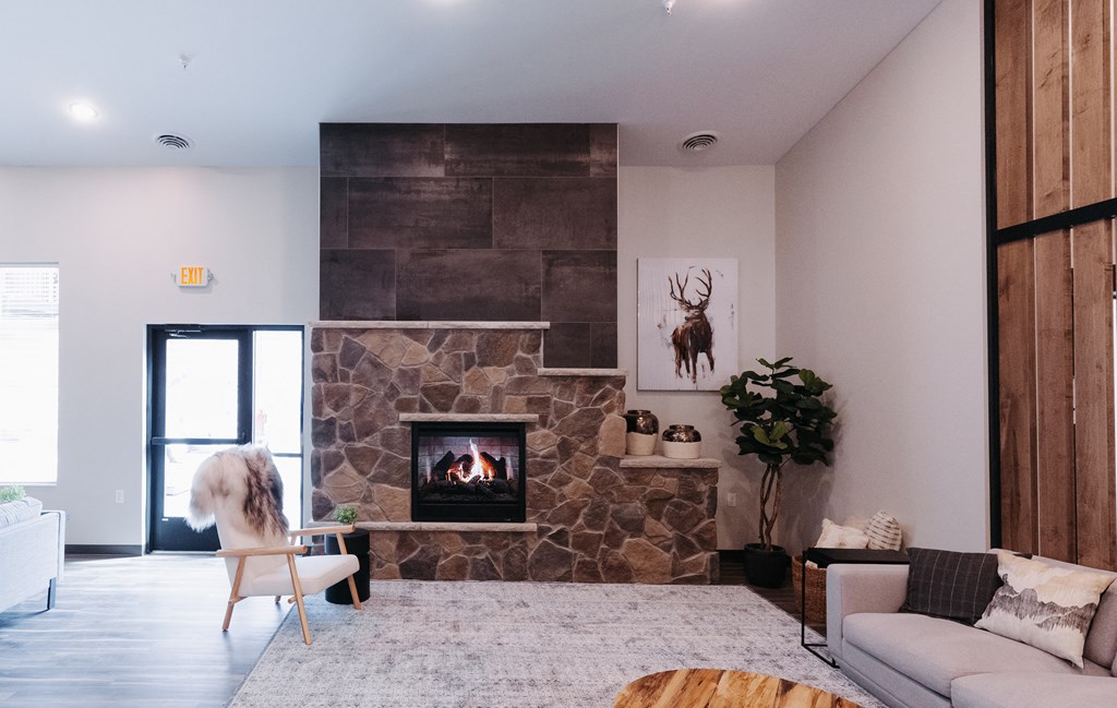 a living room with a stone fireplace and a white couch