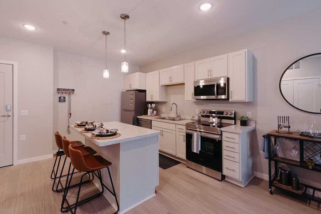 a kitchen with white cabinets and a white counter top and a black and white