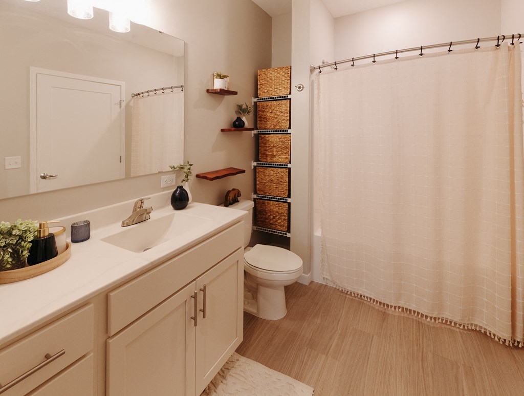 a bathroom with a shower and a sink and a toilet