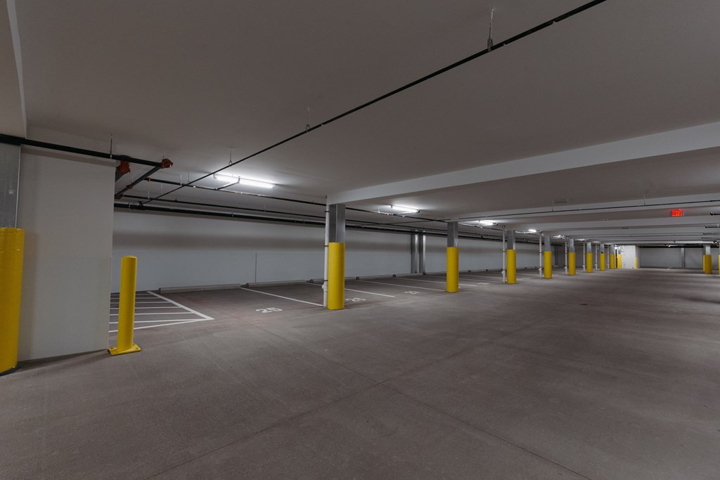a parking garage with yellow pillars and white walls