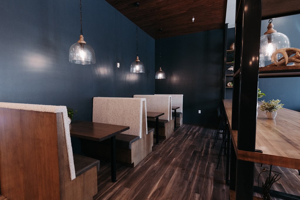 a dining room with blue walls and wooden tables and chairs