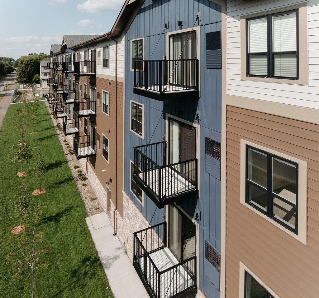a row of apartment buildings with balconies on the side of them