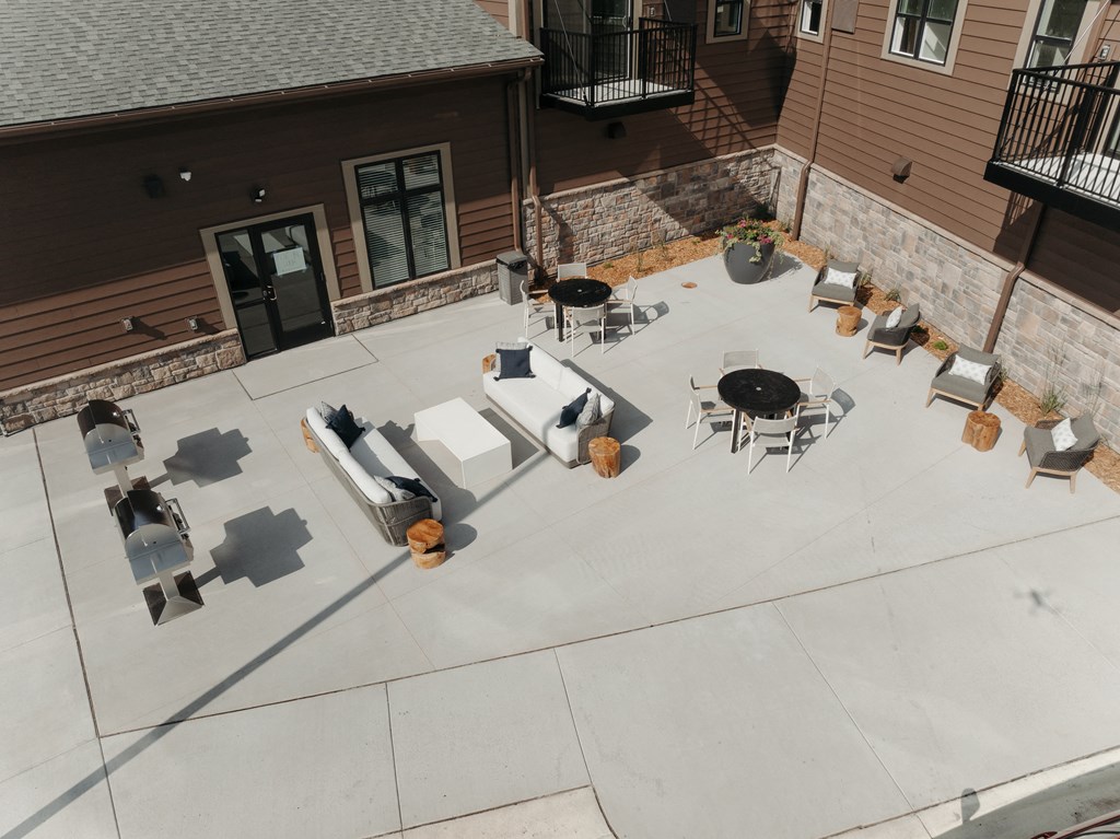 an aerial view of an outdoor patio with tables and chairs