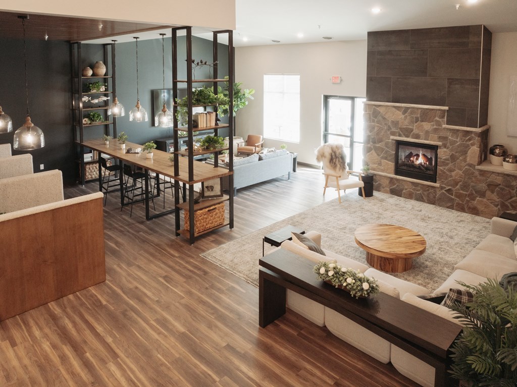 a living room with a fireplace and a dining room