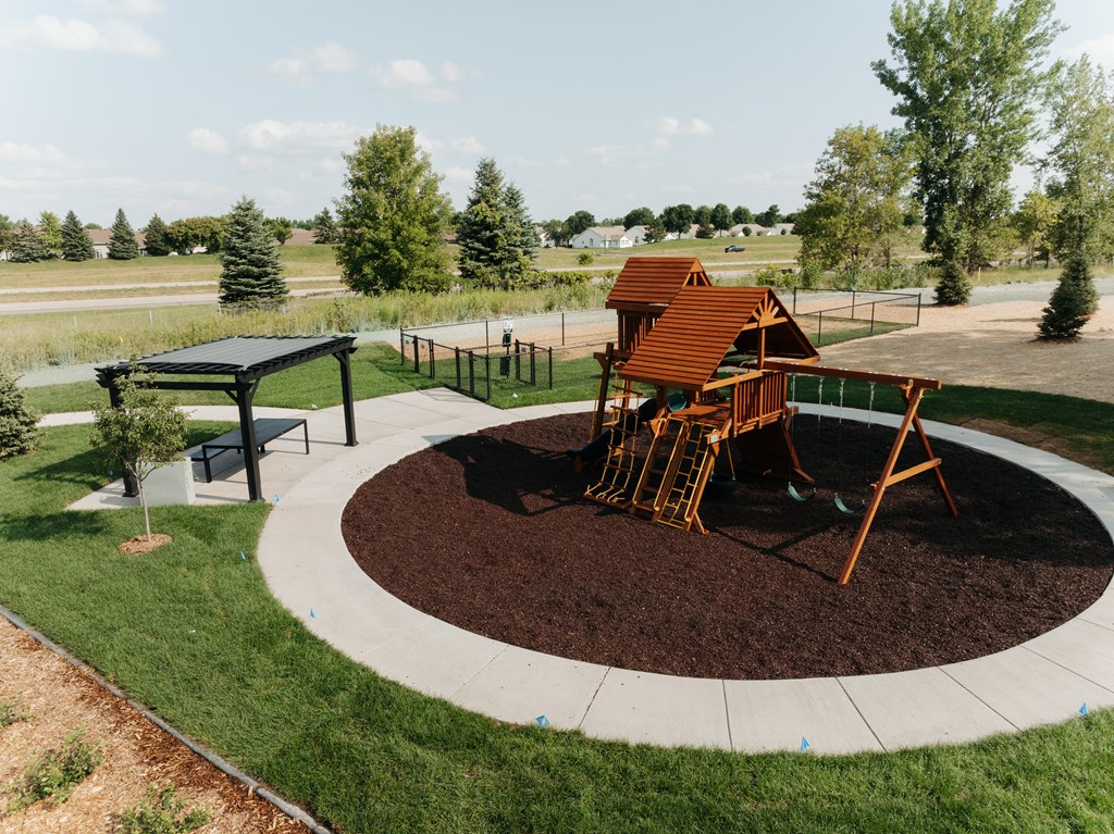 a playground with a swing set in a park