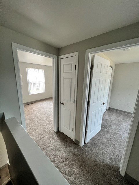 an empty living room with an open door