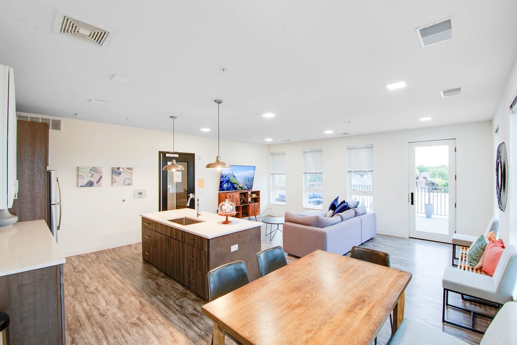 A modern kitchen with a wooden table and chairs.