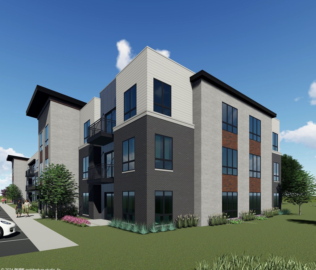 A modern multi-story building with a mix of brick and panel exterior.