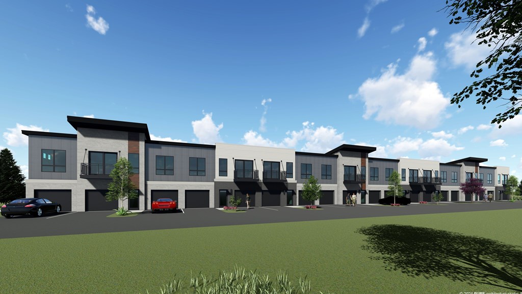 A row of modern townhouses with cars parked in front.