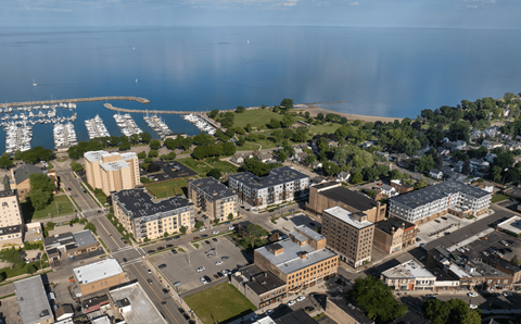 A cityscape with buildings, roads, and a marina.