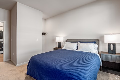 A bedroom with a large bed and two lamps at Bloom, Monona, WI, 53716