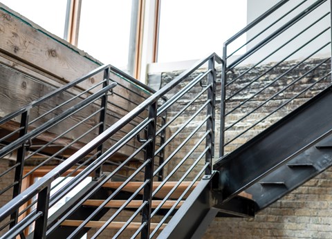 A metal staircase with wooden steps.