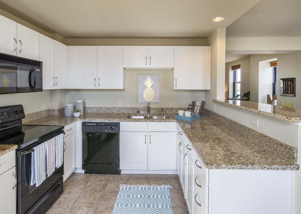 a large kitchen with stainless steel appliances and granite counter tops at Grand Wisconsin, Milwaukee, Wisconsin