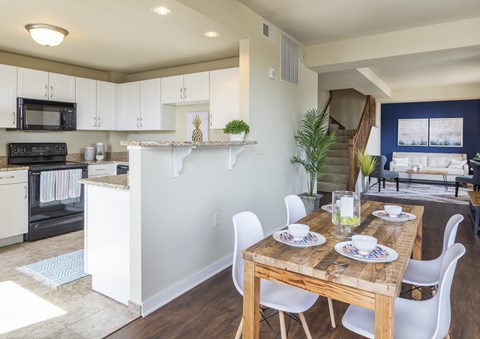 A kitchen with a dining table set for two.