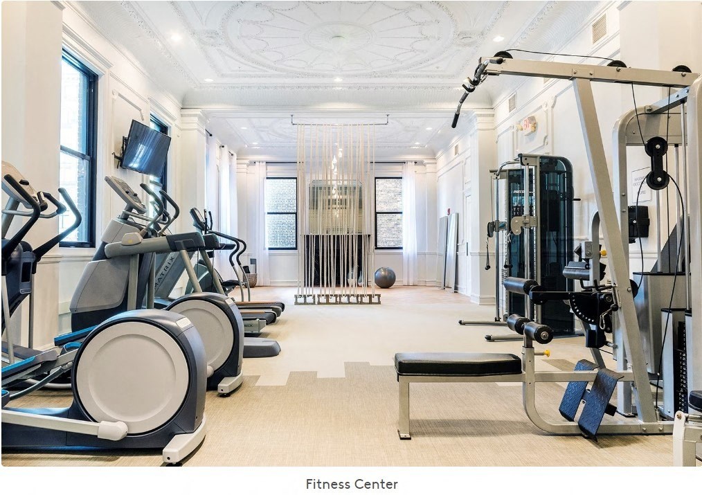 A fitness center with treadmills, elliptical machines, and weightlifting equipment at Grand Wisconsin, Wisconsin