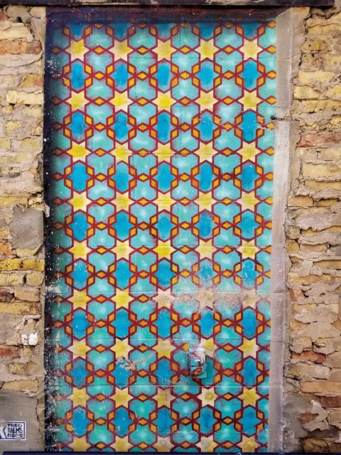 A door with a pattern of blue and yellow stars.