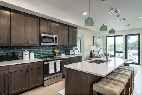 a kitchen with a large island and a sink