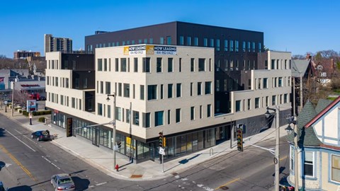 A modern building with the words "Now Lead" on the side.