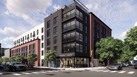A modern building with a black and red facade is depicted in the image.