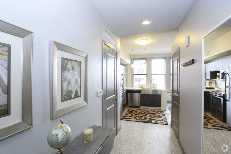A hallway with a globe and candle on a table.