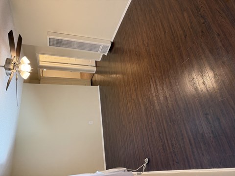 A bedroom with a ceiling fan and a bed.