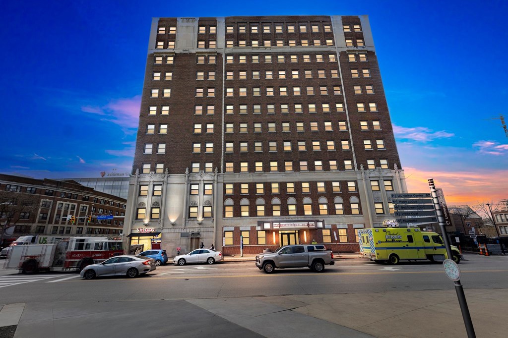 A large building with a parking lot in front of it.