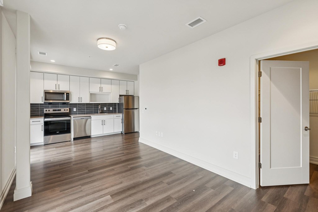 A kitchen with white cabinets and stainless steel appliances.