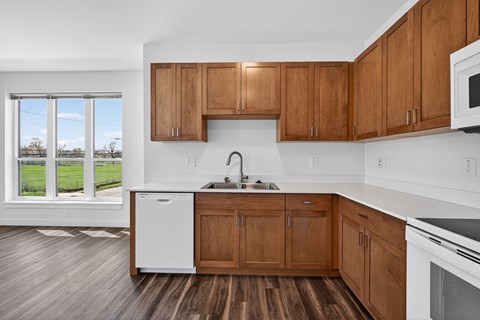 A kitchen with wooden cabinets and white appliances.