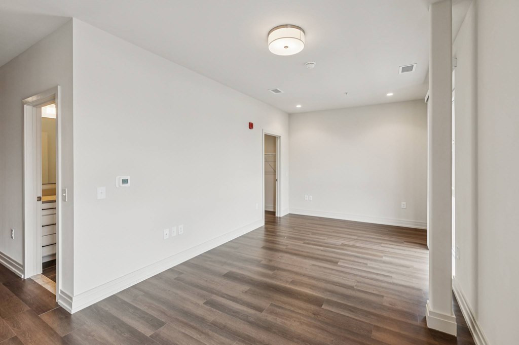 A room with wooden floors and white walls.
