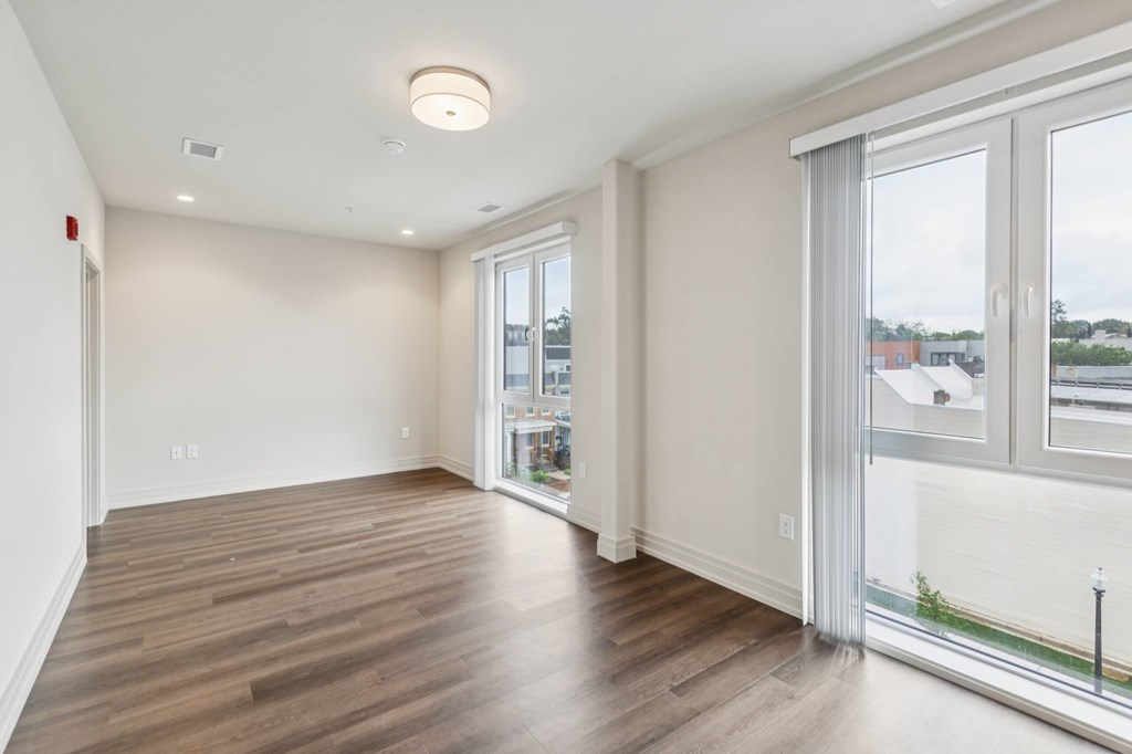 A room with a sliding glass door and a window.