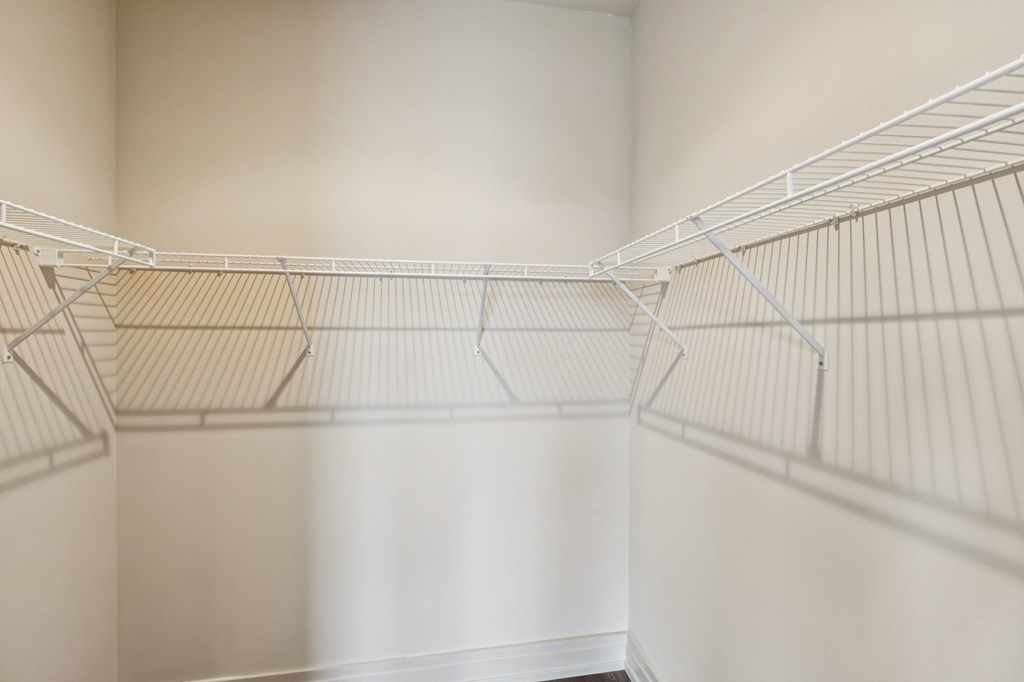 Empty white shelves in a room.