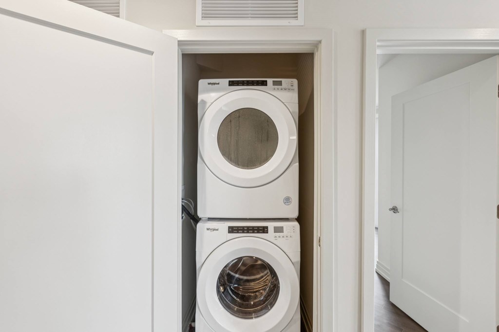 A white washing machine and dryer in a small laundry room.