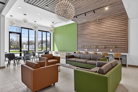 A modern living room with a green accent wall and a brown and green sofa.