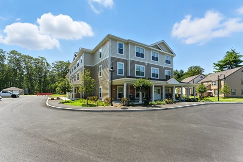 A large two-story building with a parking lot in front.