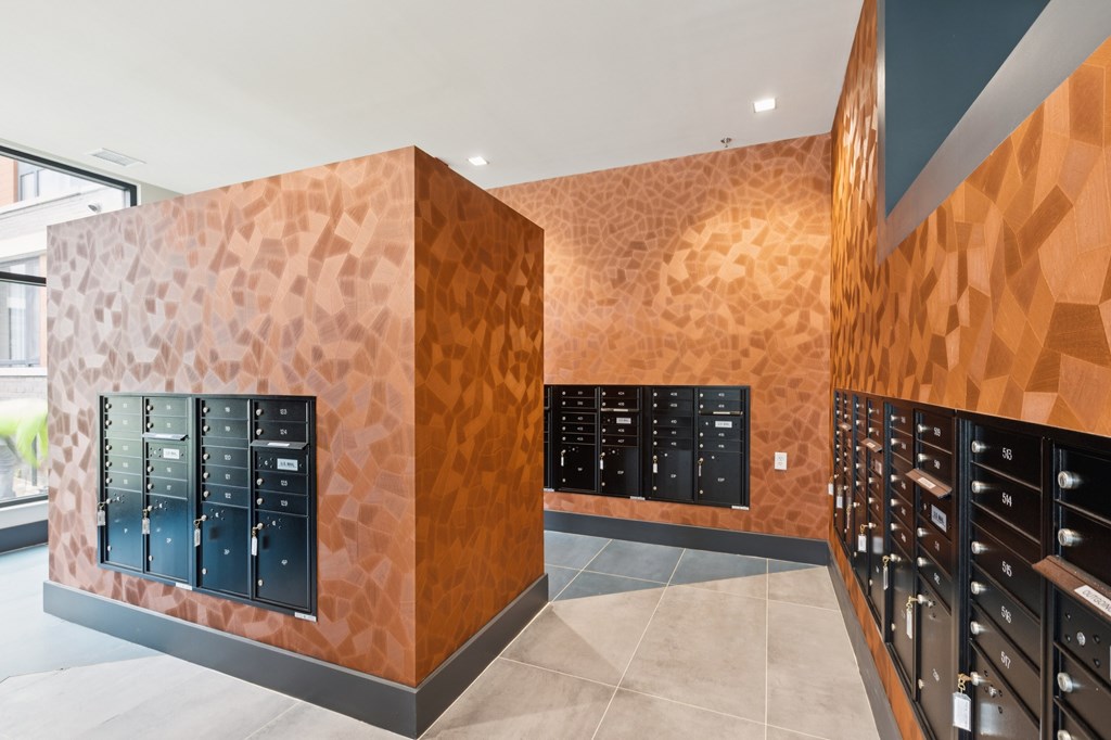 A room with a brown patterned wall and black electrical boxes.