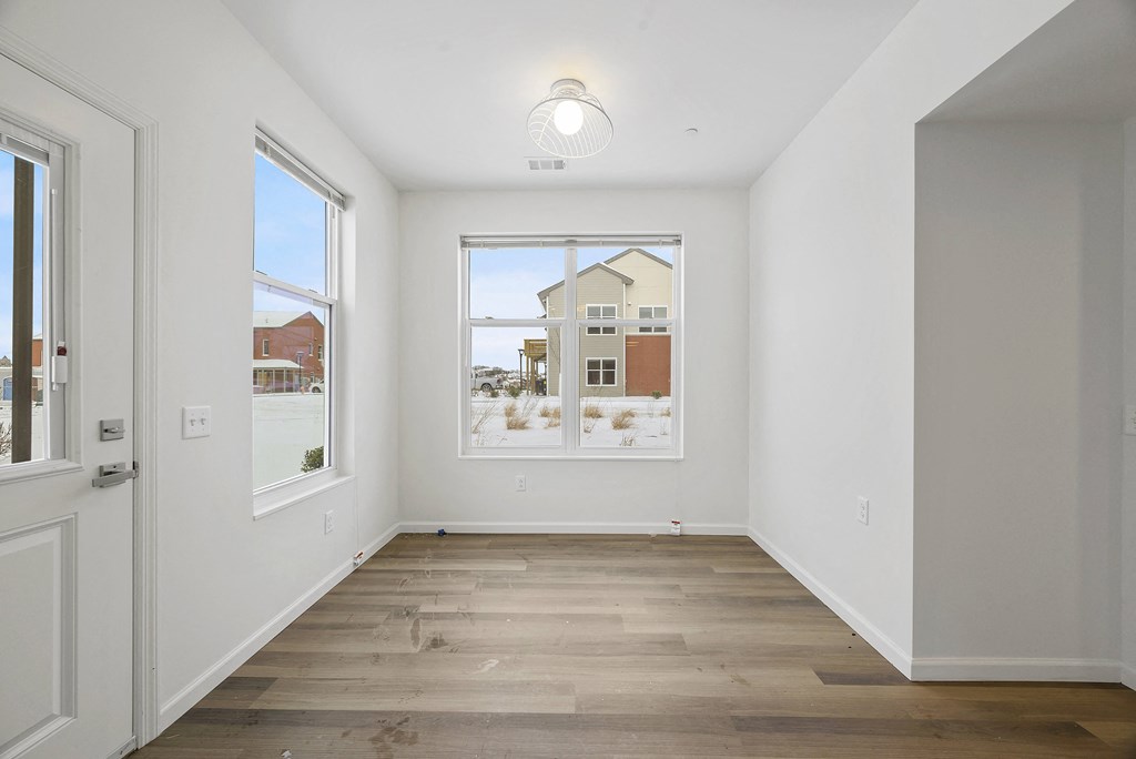 a living room with a large window and a door