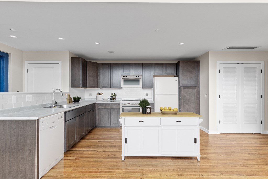a large kitchen with white cabinets and stainless steel appliances
