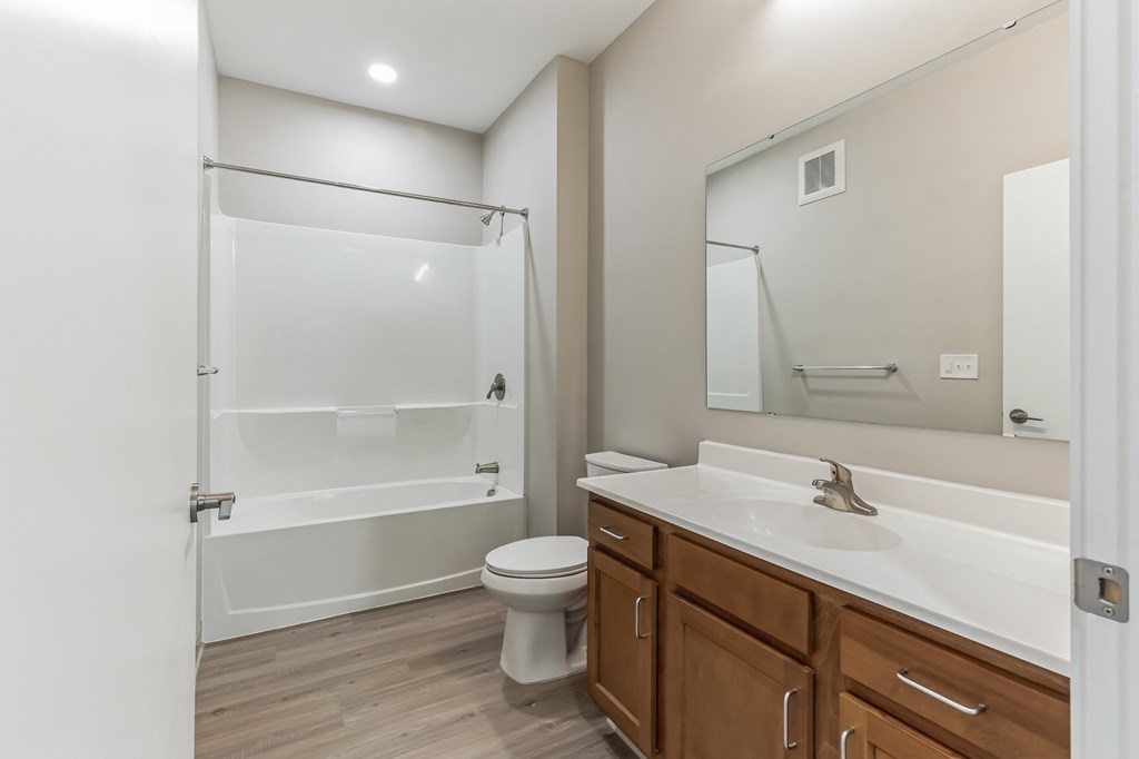 a bathroom with a toilet and a sink and a shower