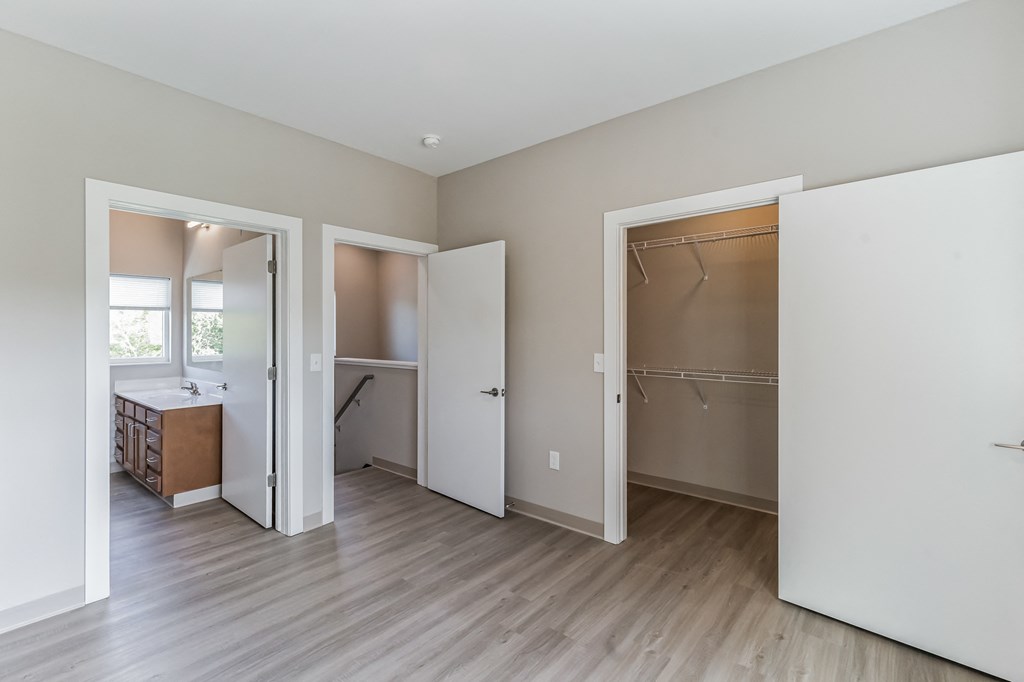 an empty room with a bathroom and a closet