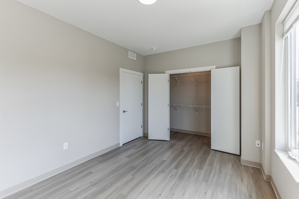 an empty room with white walls and a wooden floor