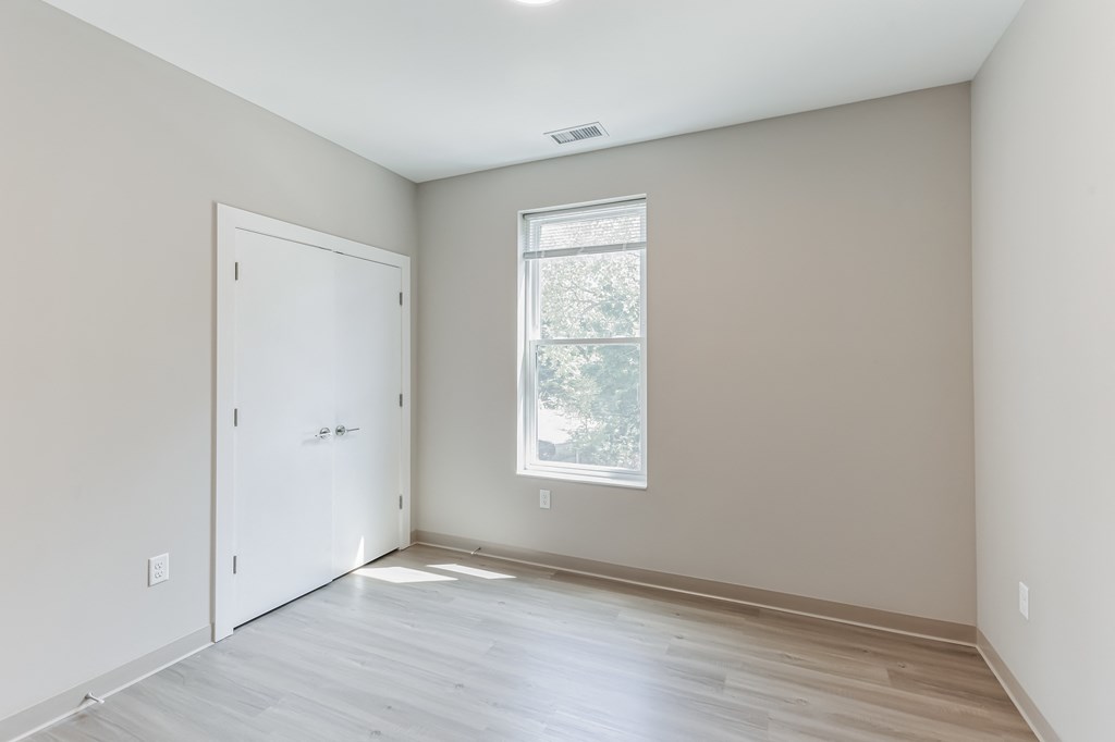 an empty room with white walls and a window