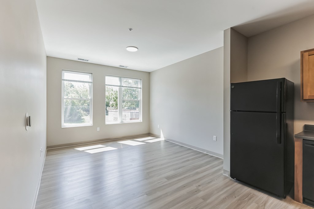 living room and fridge partial kitchen photo