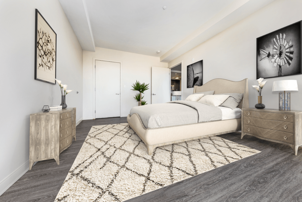 a bedroom with a large bed and a rug