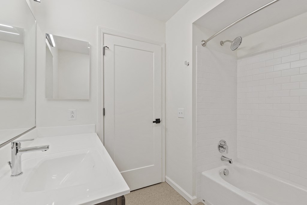 a bathroom with a sink and a tub and a shower